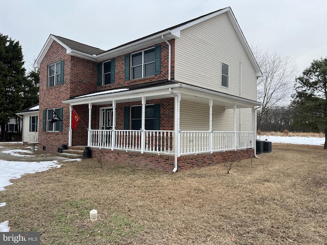 view of front of property with a porch, a front yard, and central air condition unit