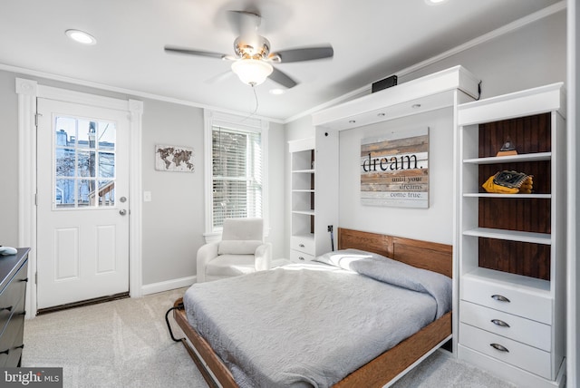 carpeted bedroom featuring multiple windows, crown molding, and ceiling fan