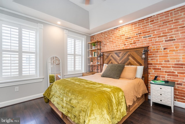 bedroom featuring ornamental molding, brick wall, and dark hardwood / wood-style floors