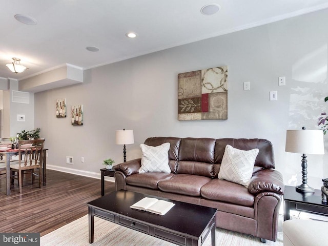 living room with hardwood / wood-style floors and crown molding