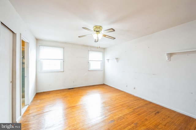 empty room with light hardwood / wood-style flooring and ceiling fan