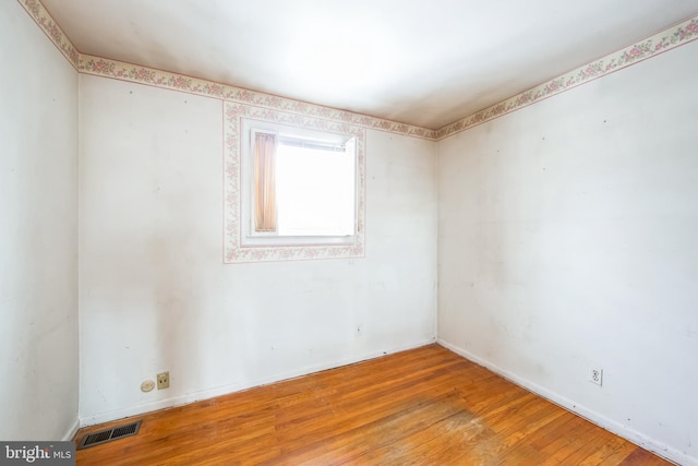 spare room with hardwood / wood-style flooring