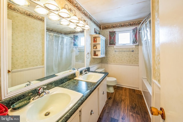 full bathroom featuring vanity, wood-type flooring, toilet, and shower / bathtub combination with curtain