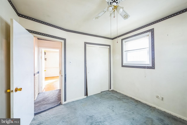 unfurnished bedroom with light colored carpet, a closet, and ceiling fan