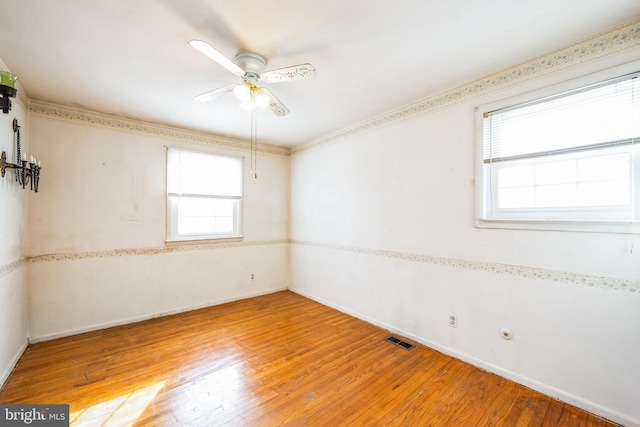 empty room featuring wood-type flooring and ceiling fan