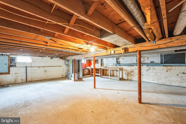 basement featuring heating unit and electric panel