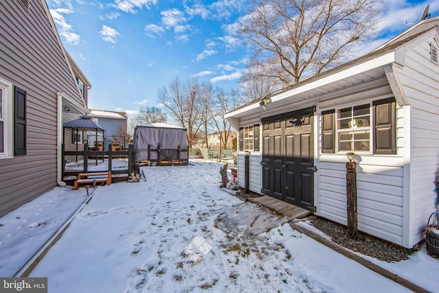 yard layered in snow with a wooden deck