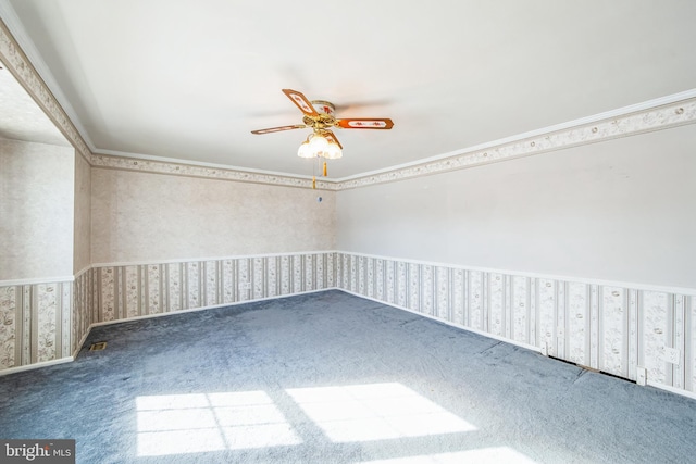 carpeted spare room featuring ceiling fan