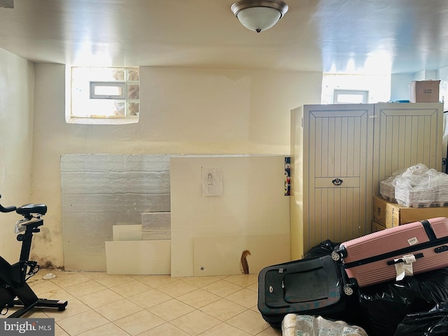 workout room featuring light tile patterned floors and plenty of natural light