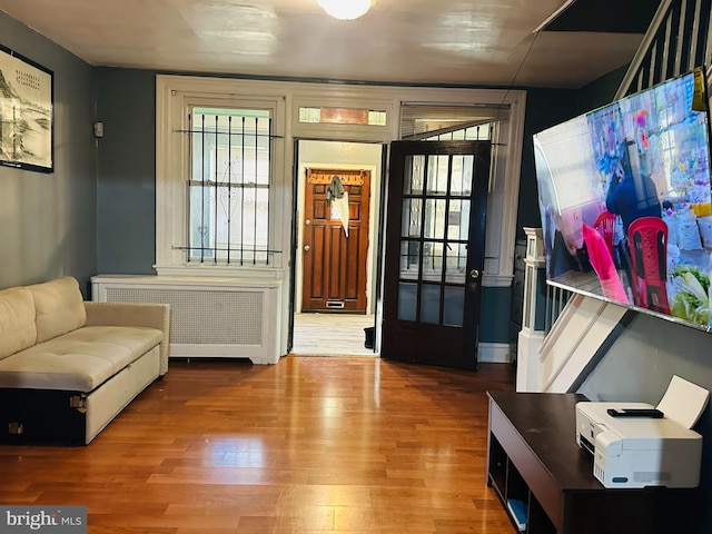 sitting room with hardwood / wood-style flooring and radiator