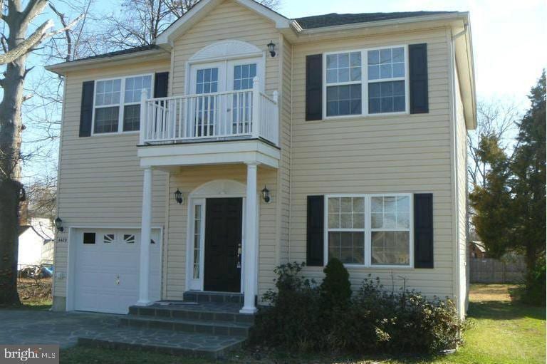 view of front of property with a balcony and a garage