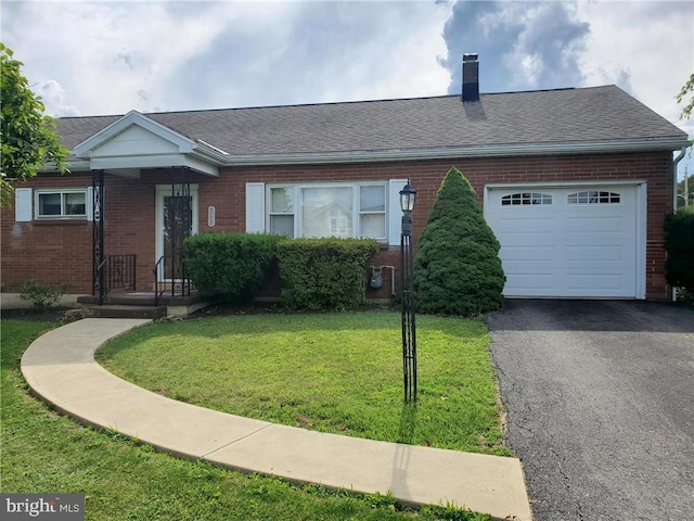 view of front facade with a garage and a front lawn