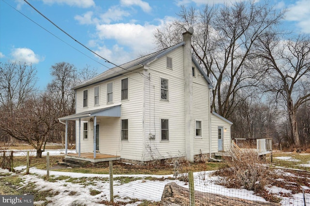 view of snow covered exterior featuring covered porch