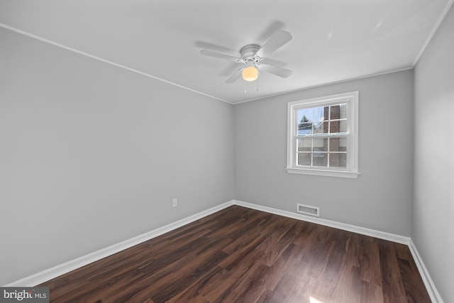 unfurnished room with dark wood-type flooring, ornamental molding, and ceiling fan