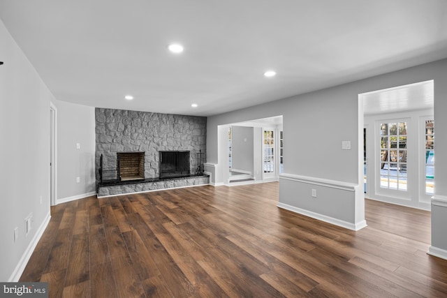 unfurnished living room with dark hardwood / wood-style floors and a fireplace