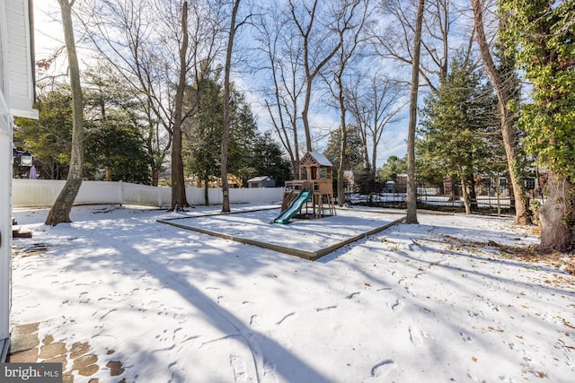 snowy yard with a playground