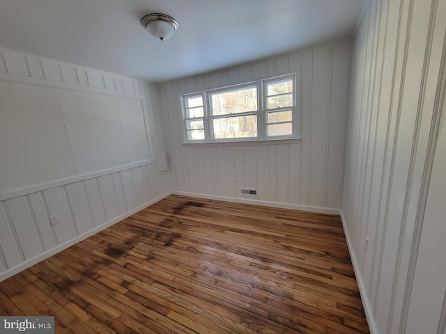 spare room with wood-type flooring