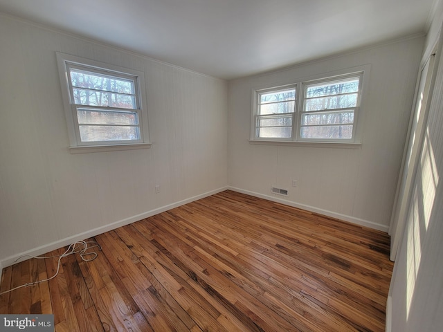 unfurnished room featuring hardwood / wood-style floors