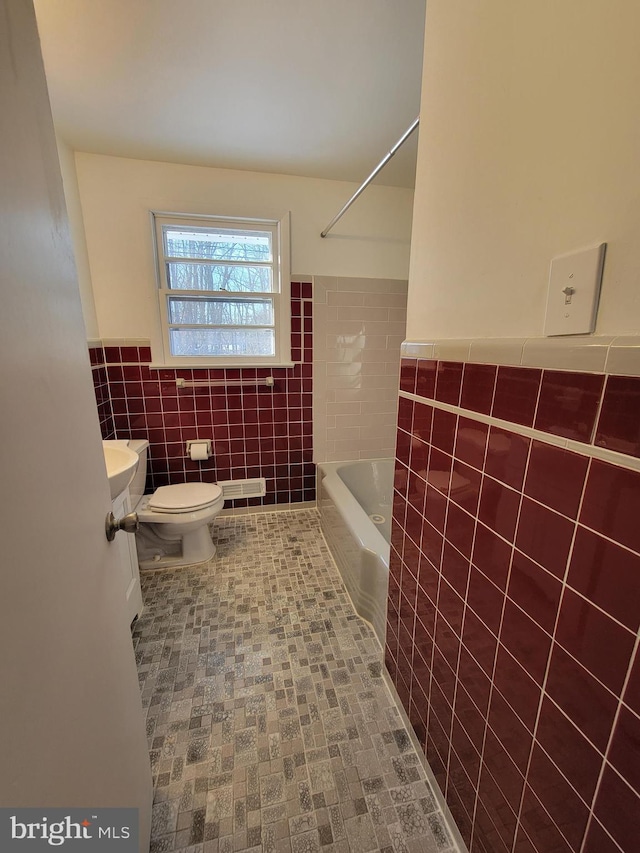 full bathroom with shower / tub combination, tile walls, vanity, and toilet