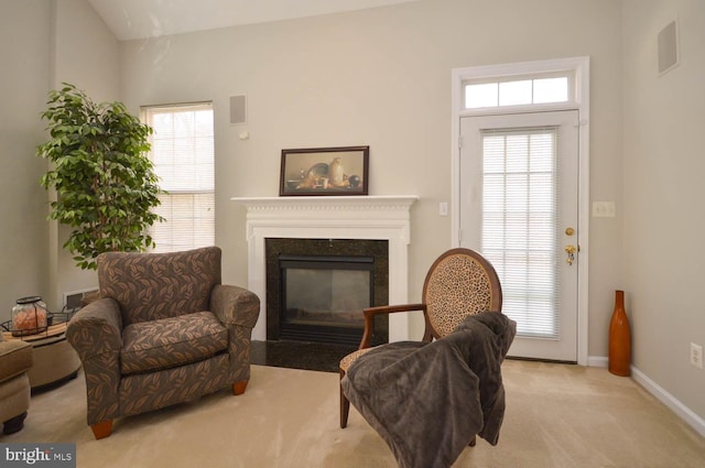 living area with light colored carpet and lofted ceiling