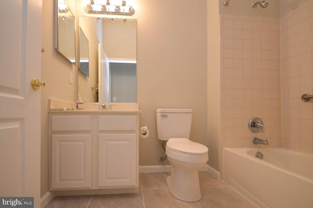 full bathroom with tile patterned flooring, tiled shower / bath, vanity, and toilet