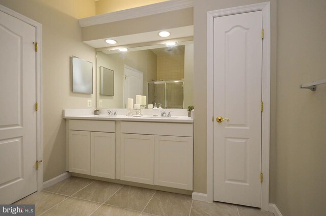 bathroom featuring an enclosed shower, vanity, and tile patterned flooring