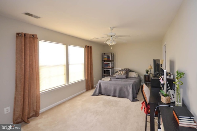 bedroom with light carpet and ceiling fan