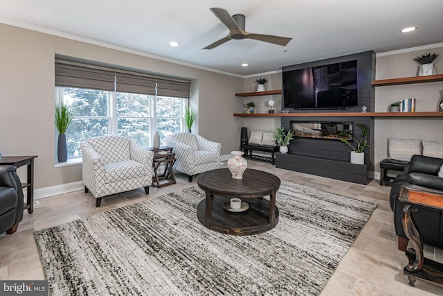 living room with crown molding, ceiling fan, and a fireplace