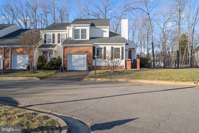 view of front of house with a garage and a front yard