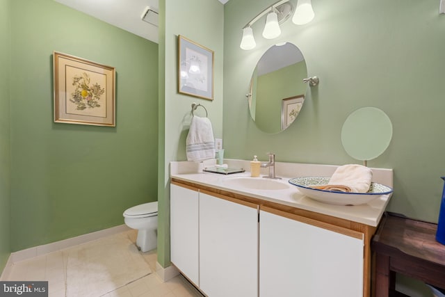 bathroom featuring vanity, tile patterned floors, and toilet