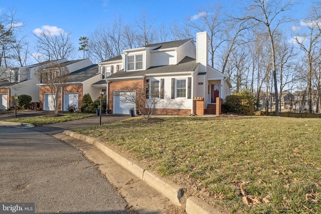 view of front of house with a garage and a front lawn