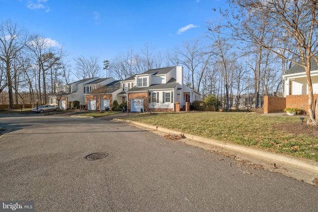 view of front facade featuring a garage and a front lawn