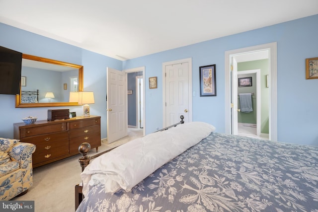 carpeted bedroom featuring ensuite bathroom