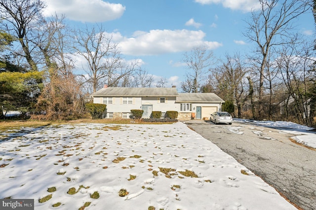 view of snow covered exterior featuring a garage