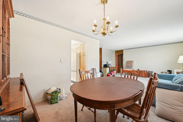 carpeted dining area with an inviting chandelier