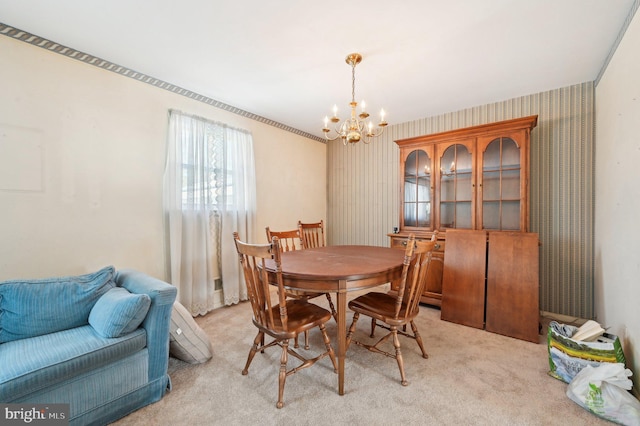 dining room with an inviting chandelier and light colored carpet