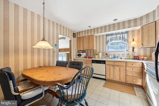 kitchen with hanging light fixtures and white appliances