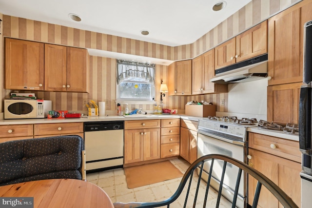 kitchen featuring white appliances and sink