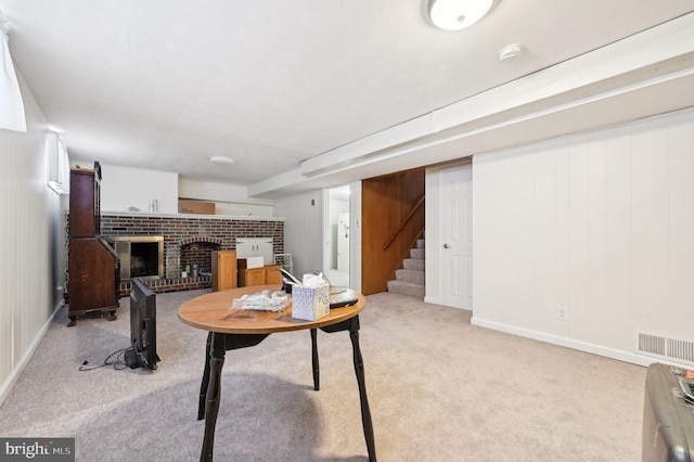 carpeted office with a fireplace