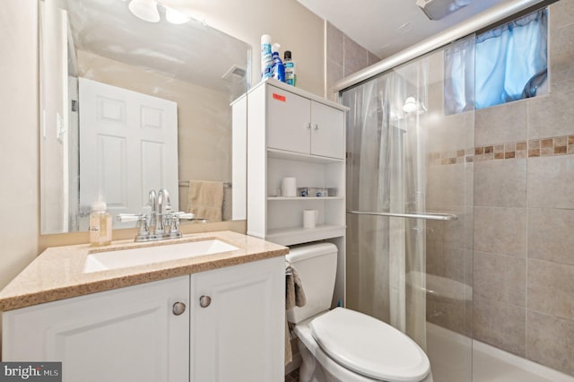 bathroom with vanity, walk in shower, and toilet