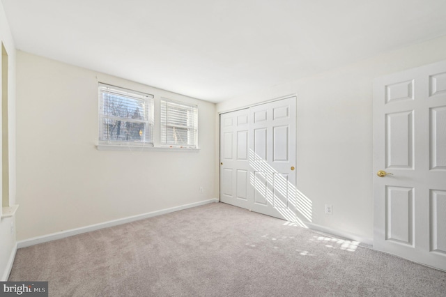 spare room featuring light colored carpet