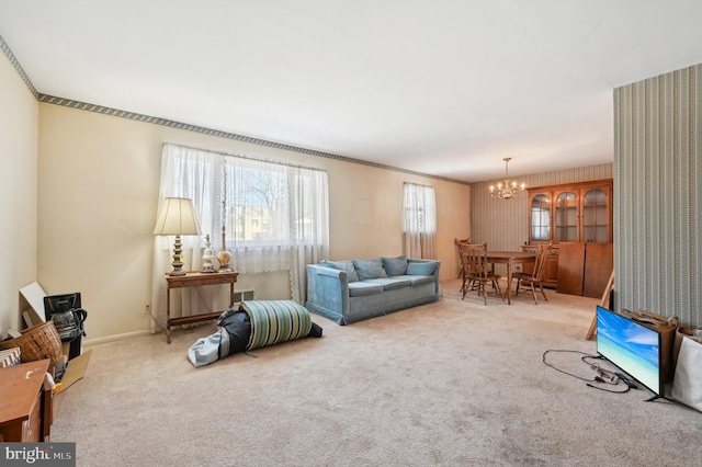 carpeted living room with an inviting chandelier