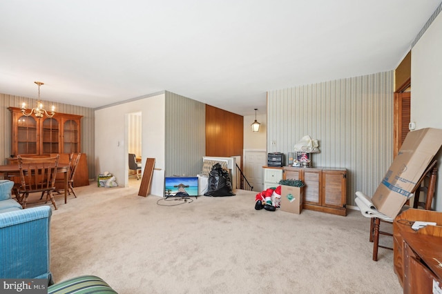 living room featuring a chandelier, light colored carpet, and wooden walls