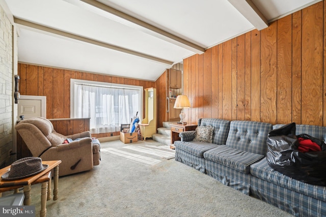 carpeted living room featuring lofted ceiling with beams and wood walls