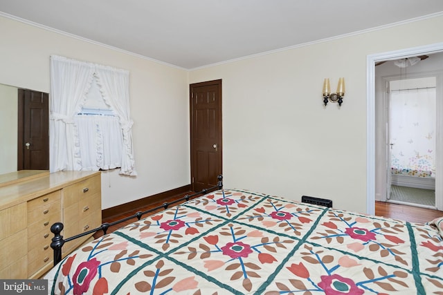 bedroom with ornamental molding and dark hardwood / wood-style flooring