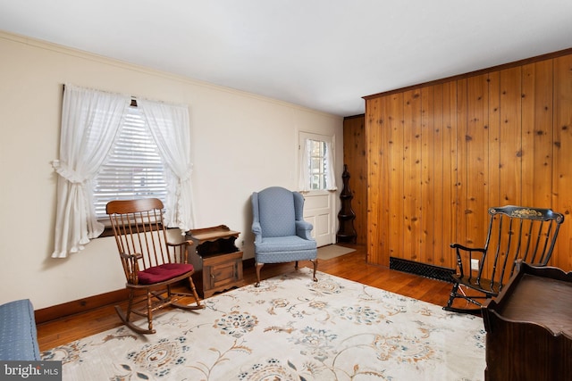 sitting room featuring hardwood / wood-style flooring and ornamental molding