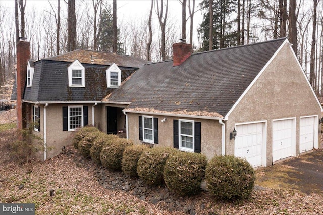 new england style home with a garage