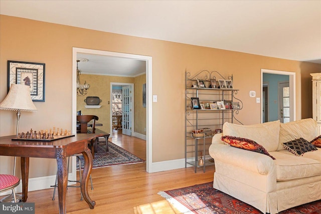 living room featuring a notable chandelier and light hardwood / wood-style floors