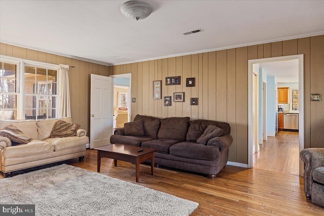 living room with ornamental molding and hardwood / wood-style floors