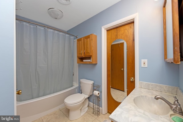 full bathroom with shower / tub combo with curtain, tile patterned floors, toilet, and vanity